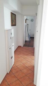 an empty hallway with a tile floor and a ladder at MAX and SUN parking privato nel prezzo in Sanremo