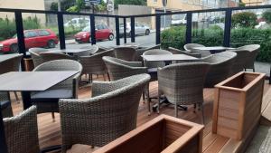 a row of tables and chairs on a balcony at Hostal Galicia Arteixo in Arteixo