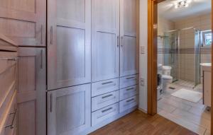 a bathroom with white cabinets and a toilet at Apartments Larst in Medulin