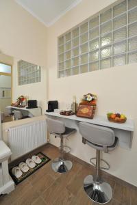 a kitchen with two bar stools and a counter at BLISS HOUSE Oradea in Oradea