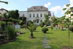 a large white house with a garden in front of it at Casa Hauth in Bernkastel-Kues