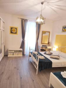 a bedroom with two beds and a chandelier at Apartman Plasse in Rijeka