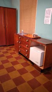 a kitchen with a dresser and a counter with a refrigerator at Antigal in Copacabana