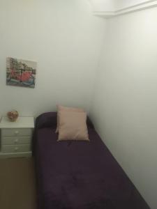 a small bedroom with a bed and a night stand at MIRADOR del BALCON DE EUROPA 1A - Nerja in Nerja