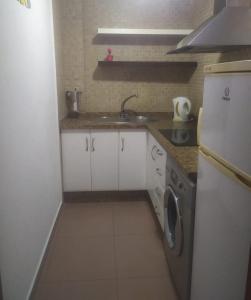 a small kitchen with a sink and a refrigerator at MIRADOR del BALCON DE EUROPA 1A - Nerja in Nerja