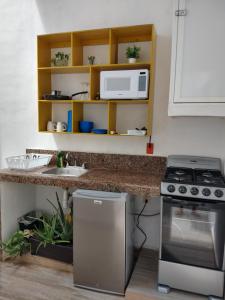 a kitchen with a stove and a sink at Casa Esencia in Cozumel