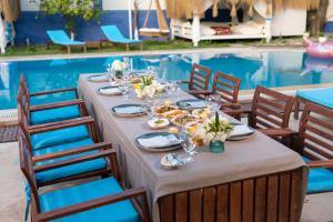 a table set for a meal next to a swimming pool at B&B Boutique Hotel in Dalyan