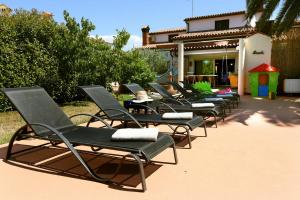 a row of lawn chairs sitting on a patio at Holiday Home Villa Margherita in Pula