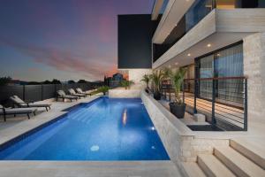 a swimming pool in the backyard of a house at Boutique Apartments Kristo in Medulin