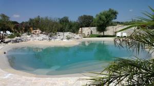 a large pool of water next to a beach at Agriturismo Kypeiros in Noto