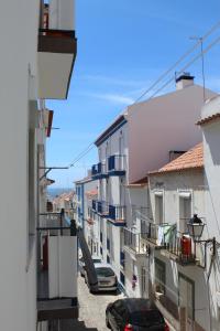 a view of a city street with cars parked at Two bedroom apartment, two minutes from the beach in Nazaré