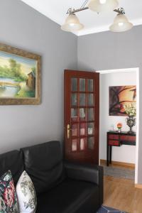 a living room with a couch and a door at Two bedroom apartment, two minutes from the beach in Nazaré
