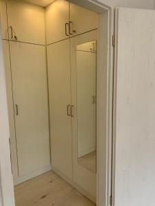 a bathroom with white cabinets and a mirror at Haus am Sonnenberg,Todtnauberg, Ferienwohnung 105, direkt am Skilift-Skipiste, Nähe Feldberg in Todtnauberg