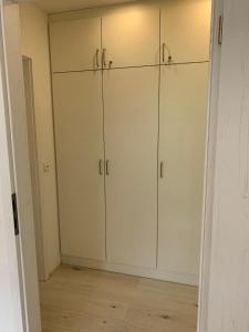 a white closet with white cabinets in a room at Haus am Sonnenberg,Todtnauberg, Ferienwohnung 105, direkt am Skilift-Skipiste, Nähe Feldberg in Todtnauberg