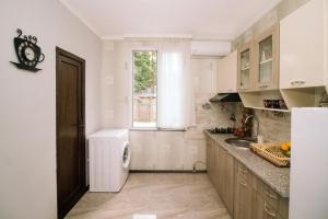a white kitchen with a sink and a window at Apartment in Chakvi in Chakvi