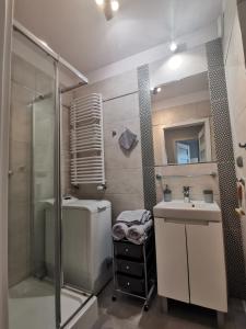 a bathroom with a shower and a sink and a toilet at Elegant & Cosy in Wrocław