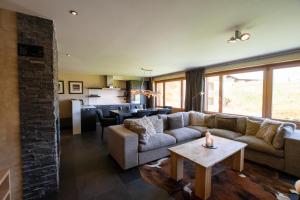 a living room with a couch and a table at Apartment Caspar in Riederalp