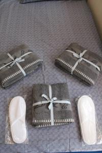 four pairs of shoes are sitting on a bed at HOLIDAY KAVALA in Kavala