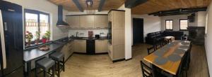 a kitchen and living room with a table and chairs at Casa Bunicii in Şarul Dornei