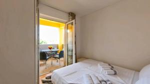 a bedroom with a bed and a table and a mirror at Apartments Dario in Medulin