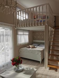 a bedroom with a bunk bed and a staircase at Sapņi in Kolka