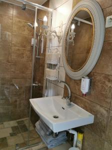 a bathroom with a sink and a mirror at Sapņi in Kolka