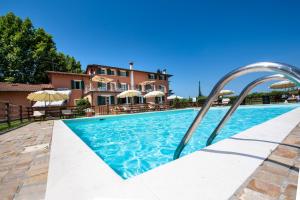 a pool with a water slide in front of a house at Relais Villa Isabel in Pietrasanta