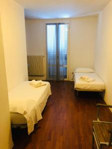 a room with two beds and a window at CASA CENTRO STORICO RIMINI in Rimini