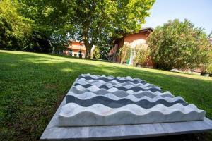 a large rock sitting in the grass in a field at Relais Villa Isabel in Pietrasanta