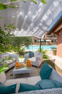 a patio with couches and a table with pillows at Relais Villa Isabel in Pietrasanta