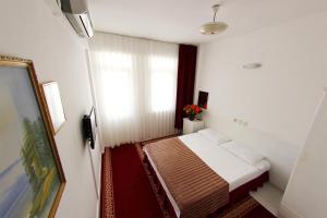 Postel nebo postele na pokoji v ubytování Soykan Hotel