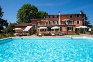 a large pool in front of a house at Relais Villa Isabel in Pietrasanta