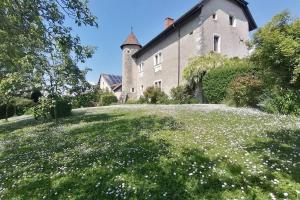 a field of flowers in front of a building at Le Domaine du Château in Seynod