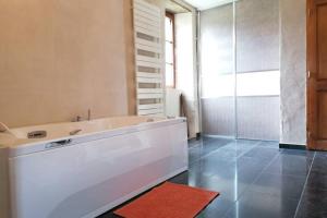 a bathroom with a tub and a glass shower at Le Domaine du Château in Seynod +27 photos