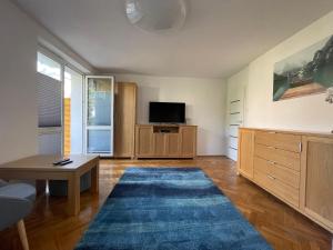 a large living room with a tv and a table at Apartament Basia in Gdynia