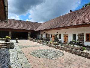 a building with a tile roof and a patio at Statek Ctiboř in Ctiboř