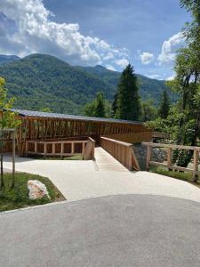 a wooden bridge with a view of the mountains at Apartma Nina in Bohinj