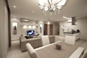 een woonkamer met een bank en een kroonluchter bij Summer Breeze in Sliema