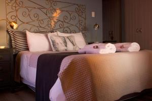 a bedroom with a bed with two stuffed animals on it at Dreamy Beach Room in Melkbosstrand