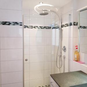 a shower with a glass door in a bathroom at Eligo in Friedrichshafen