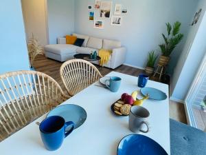 un tavolo con tazze blu e ciotole in soggiorno di Fewo Lieblingsort Norddeich a Norddeich