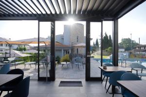 a view of a patio with tables and chairs at Best Western Plus Sabaudia Hotel in Sabaudia