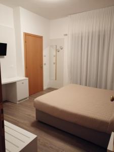 Postel nebo postele na pokoji v ubytování Hotel Columbia & Ninfea