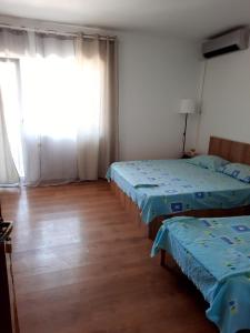 Postel nebo postele na pokoji v ubytování VILA SAMI