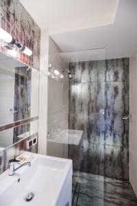 a white bathroom with a sink and a shower at Apartament Podwale in Łańcut