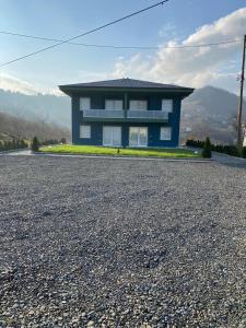 a blue house sitting on top of a gravel road at Sea and Natural Adalet Suits in Trabzon