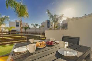a table with plates of food on top of a balcony at Bahia Homes Residencial in La Horadada