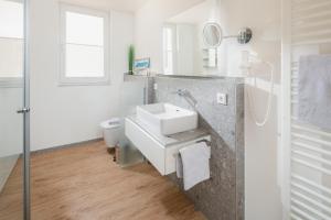 a bathroom with a sink and a toilet at Düsseldorfer Hof Norderney A1 in Norderney +30 photos