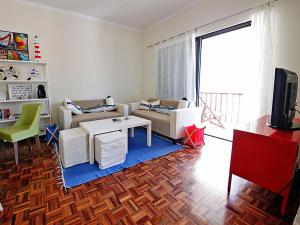 a living room with a couch and a table at Roaz de Bandeira Guesthouse in Olhão +39 photos