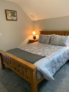 a bedroom with a wooden bed in a room at Keeraun Hill in Banagher